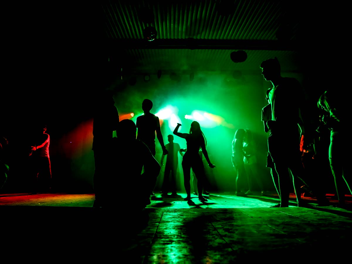 Dance floor at a club, lit green and red